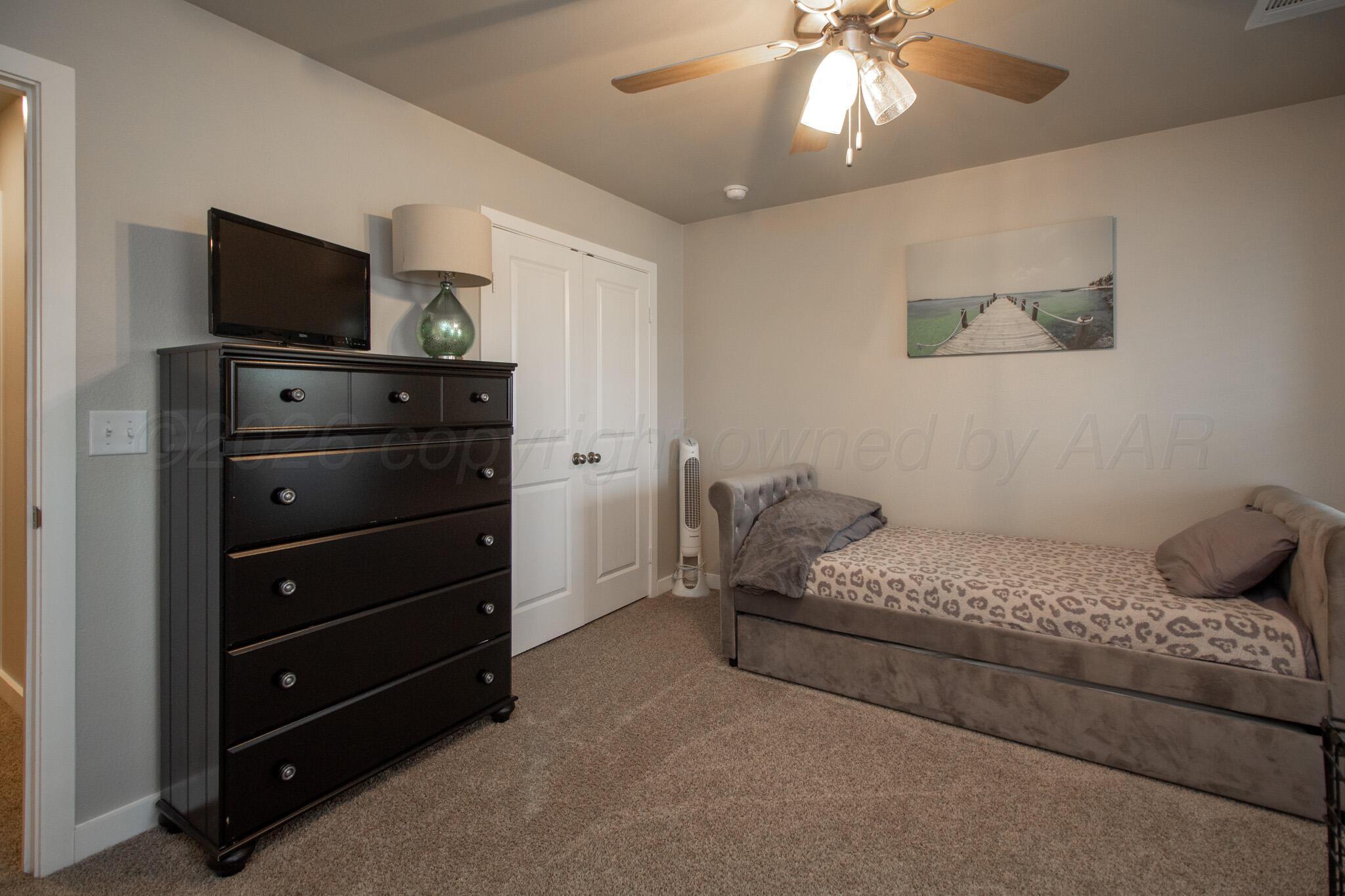 1541 Wesleyan Street Amarillo, TX 79118 - Photo 16 of 23 a bedroom with a bed and a television