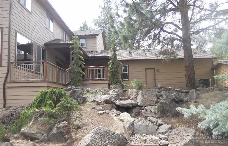 60120 East Ridgeview Drive Bend, OR 97702 - Photo 2 of 14 front view of a house with a large tree