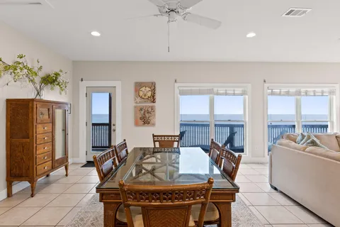 a living room with furniture a flat screen tv and a large window