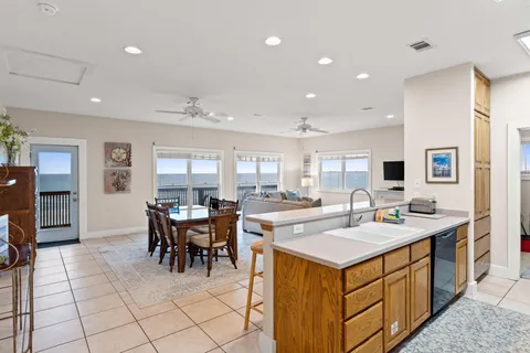 a kitchen with a sink and chairs