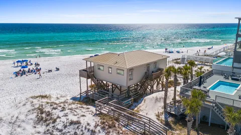 an aerial view of a house with a ocean view