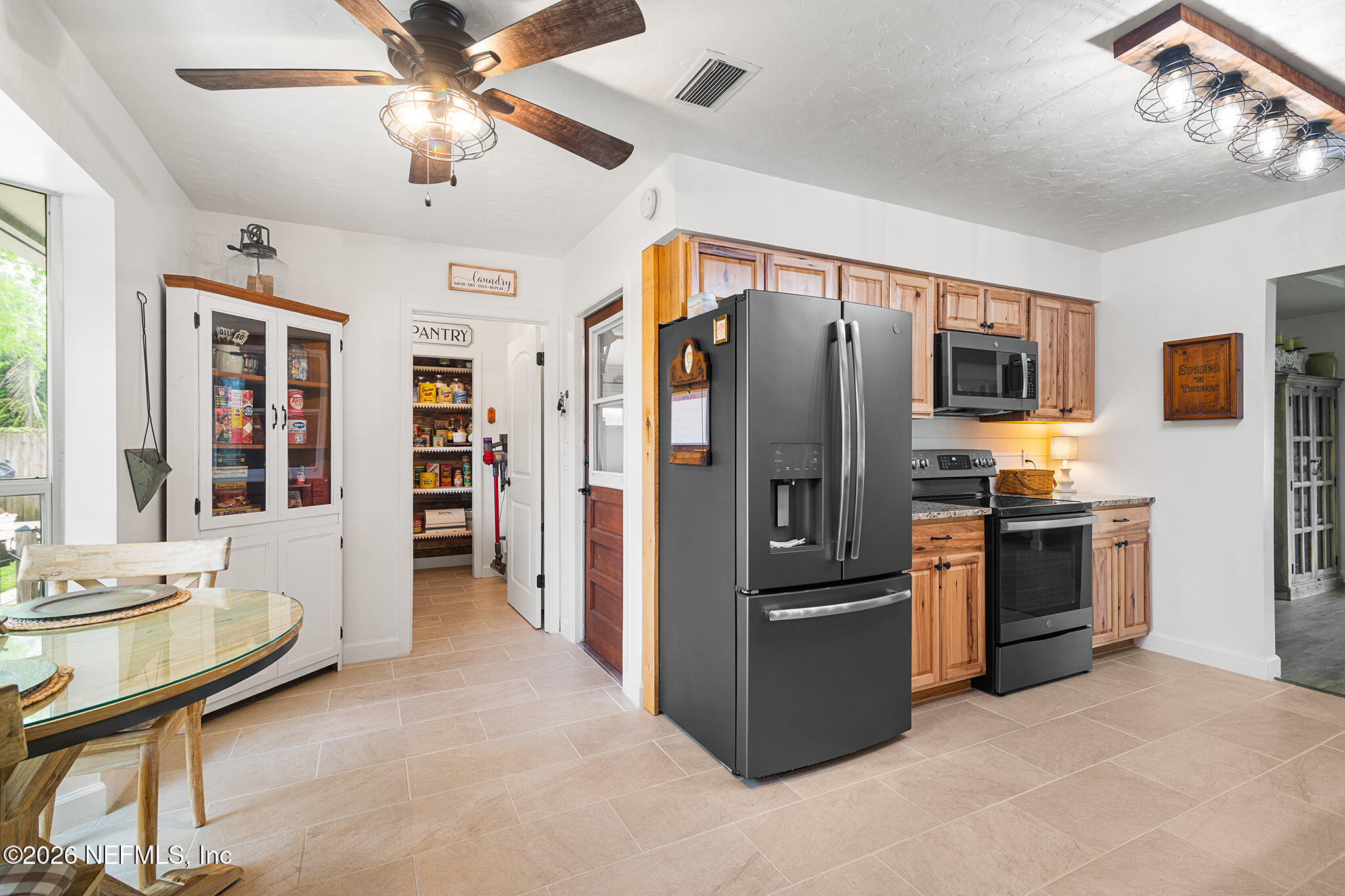 8208 Worm Wood Road Jacksonville, FL 32210 - Photo 17 of 35 a kitchen with stainless steel appliances kitchen island a refrigerator and a stove