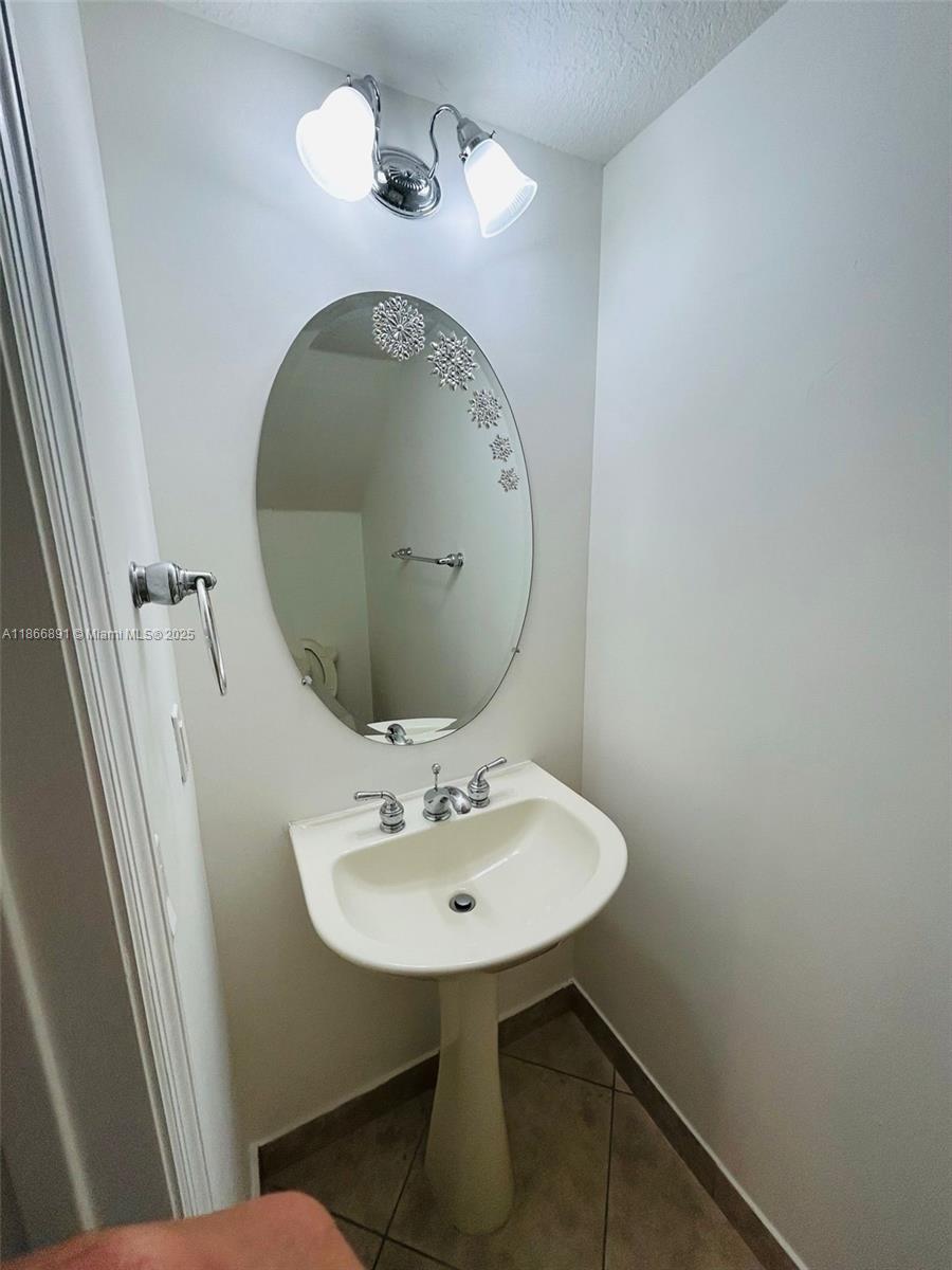 22129 Majestic Woods Way, Unit 504 Boca Raton, FL 33428 - Photo 11 of 23 a bathroom with a sink mirror and toilet