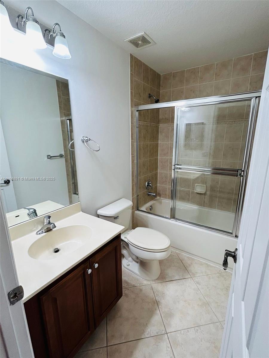 22129 Majestic Woods Way, Unit 504 Boca Raton, FL 33428 - Photo 17 of 23 a bathroom with a sink toilet and shower