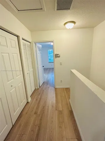 a view of a room with wooden floor