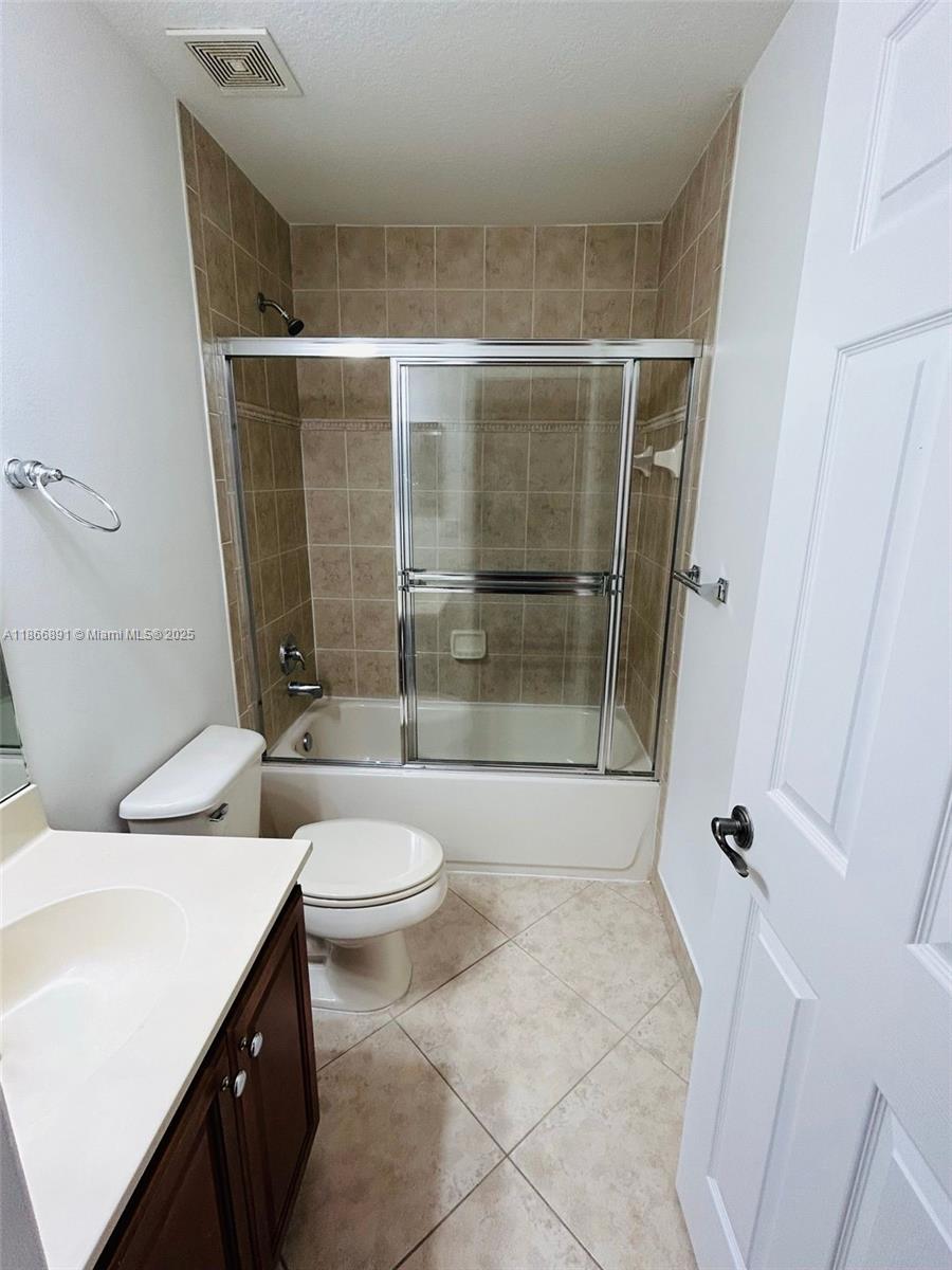 22129 Majestic Woods Way, Unit 504 Boca Raton, FL 33428 - Photo 19 of 23 a bathroom with a toilet and a shower