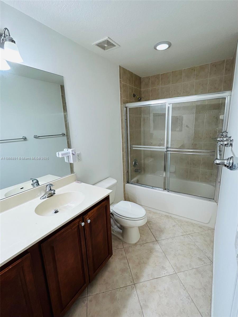 22129 Majestic Woods Way, Unit 504 Boca Raton, FL 33428 - Photo 21 of 23 a bathroom with a sink a toilet and shower