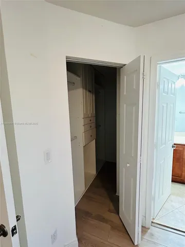 a view of hallway with wooden floor