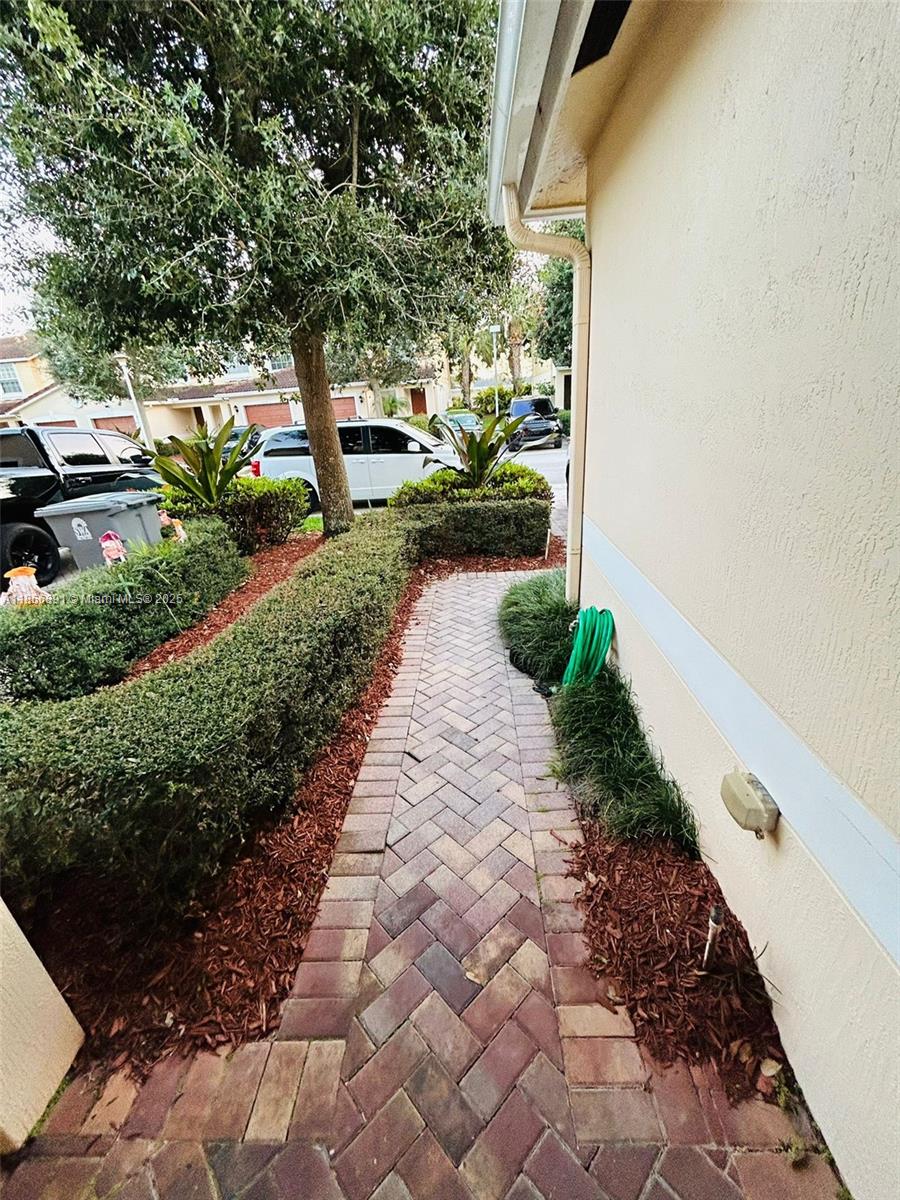 22129 Majestic Woods Way, Unit 504 Boca Raton, FL 33428 - Photo 4 of 23 a view of a pathway with a yard