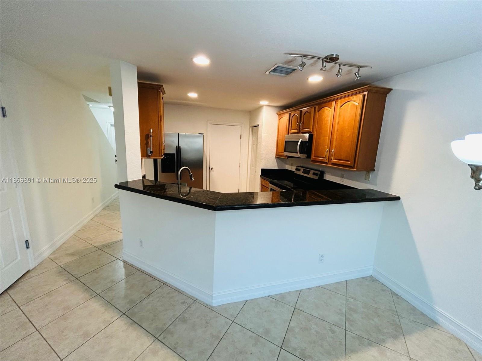 22129 Majestic Woods Way, Unit 504 Boca Raton, FL 33428 - Photo 6 of 23 a kitchen with a sink and cabinets