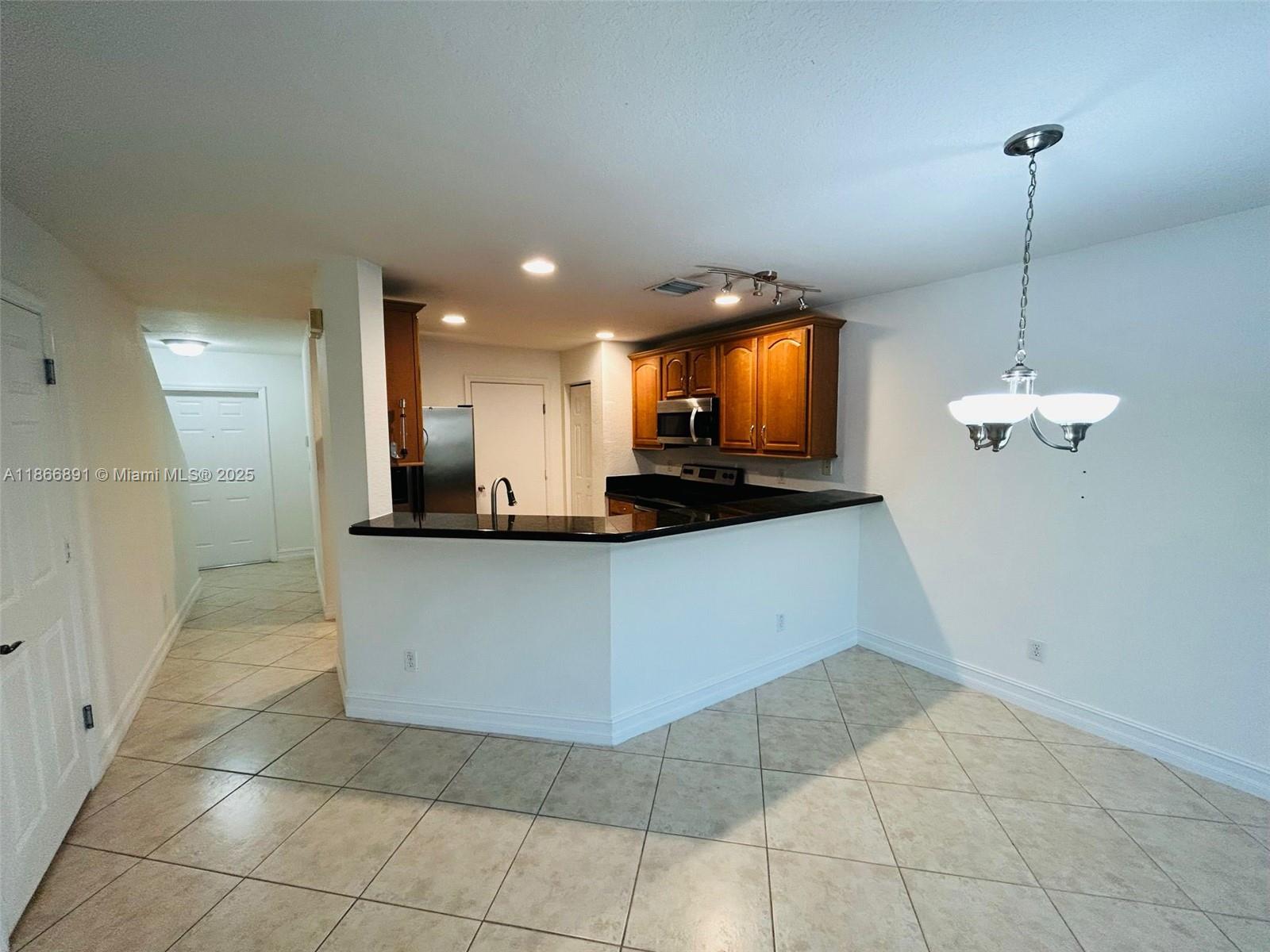 22129 Majestic Woods Way, Unit 504 Boca Raton, FL 33428 - Photo 7 of 23 a view of kitchen with refrigerator and microwave