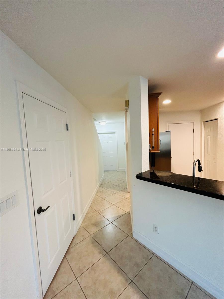 22129 Majestic Woods Way, Unit 504 Boca Raton, FL 33428 - Photo 10 of 23 a kitchen with granite countertop a sink and a stove top oven