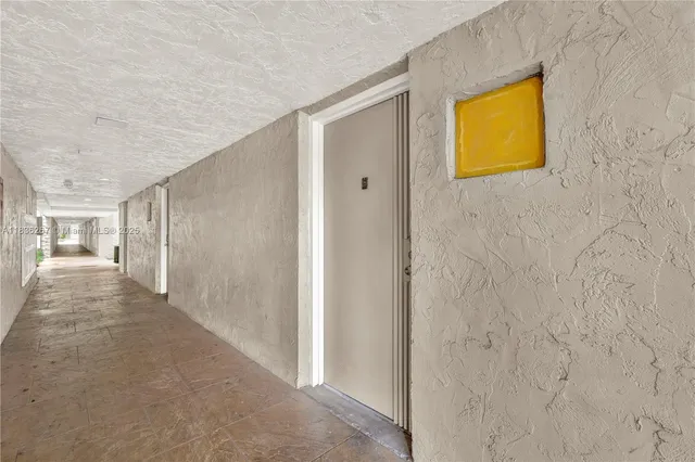 a view of a yard with plants and a table