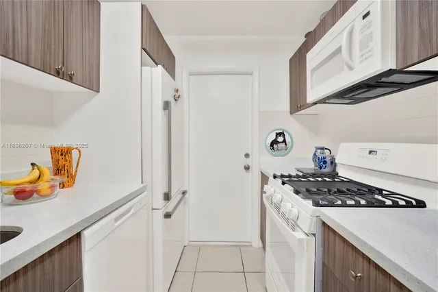 a kitchen with stainless steel appliances a stove a sink and a refrigerator
