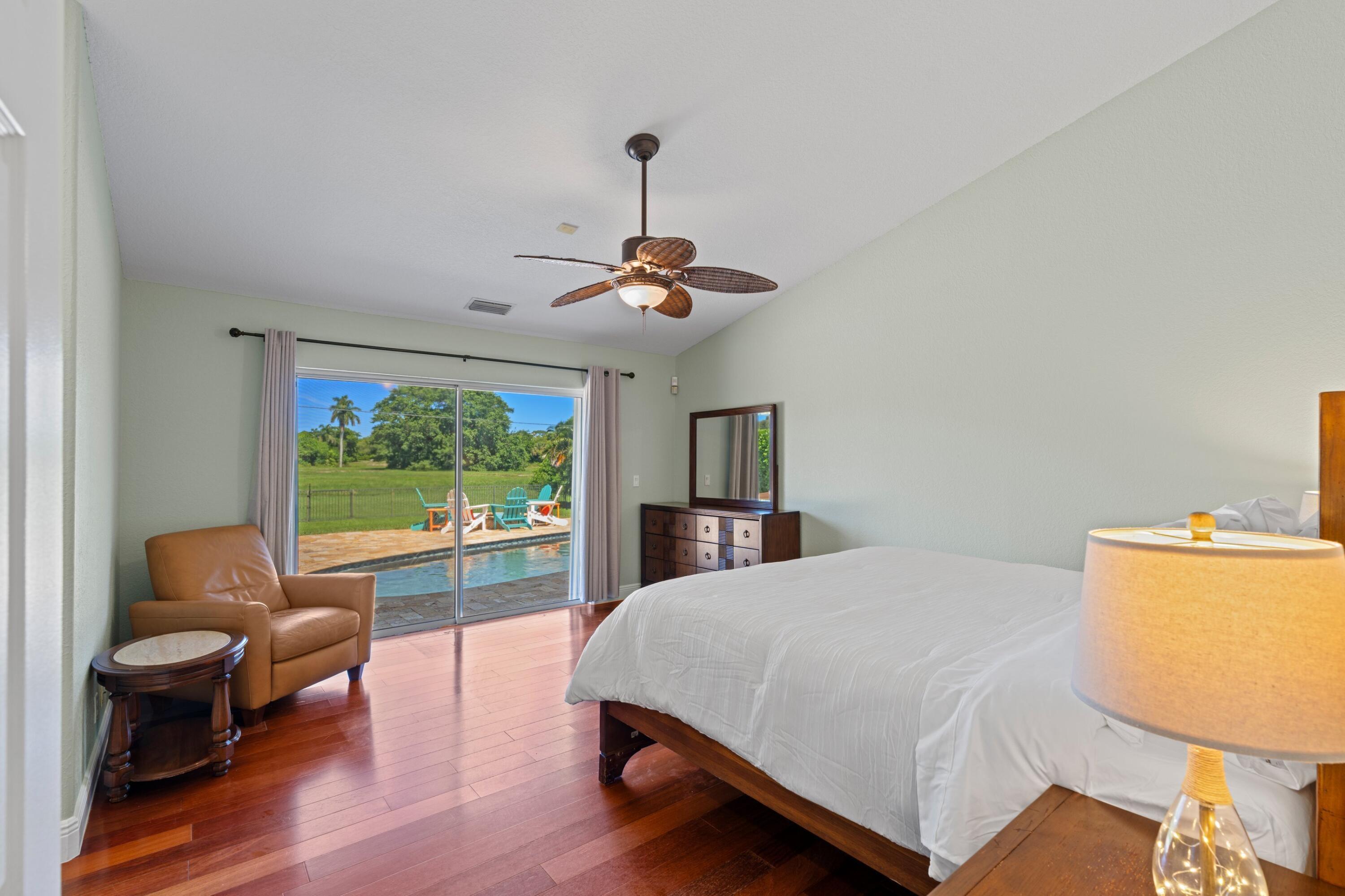 7598 Fairway Trail Boca Raton, FL 33487 - Photo 11 of 50 a bedroom with a bed and a large window