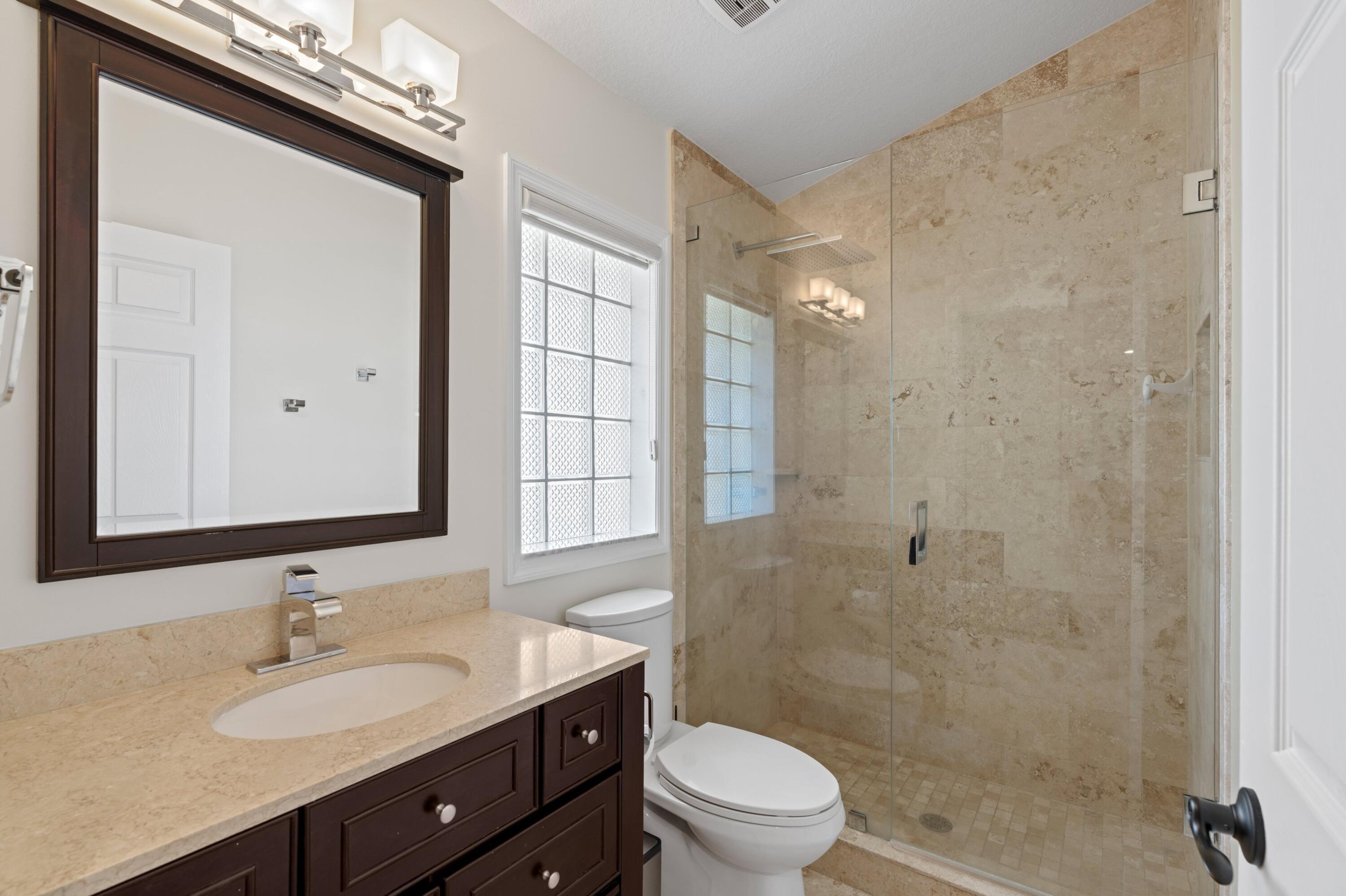 7598 Fairway Trail Boca Raton, FL 33487 - Photo 14 of 50 a bathroom with a sink a toilet and shower