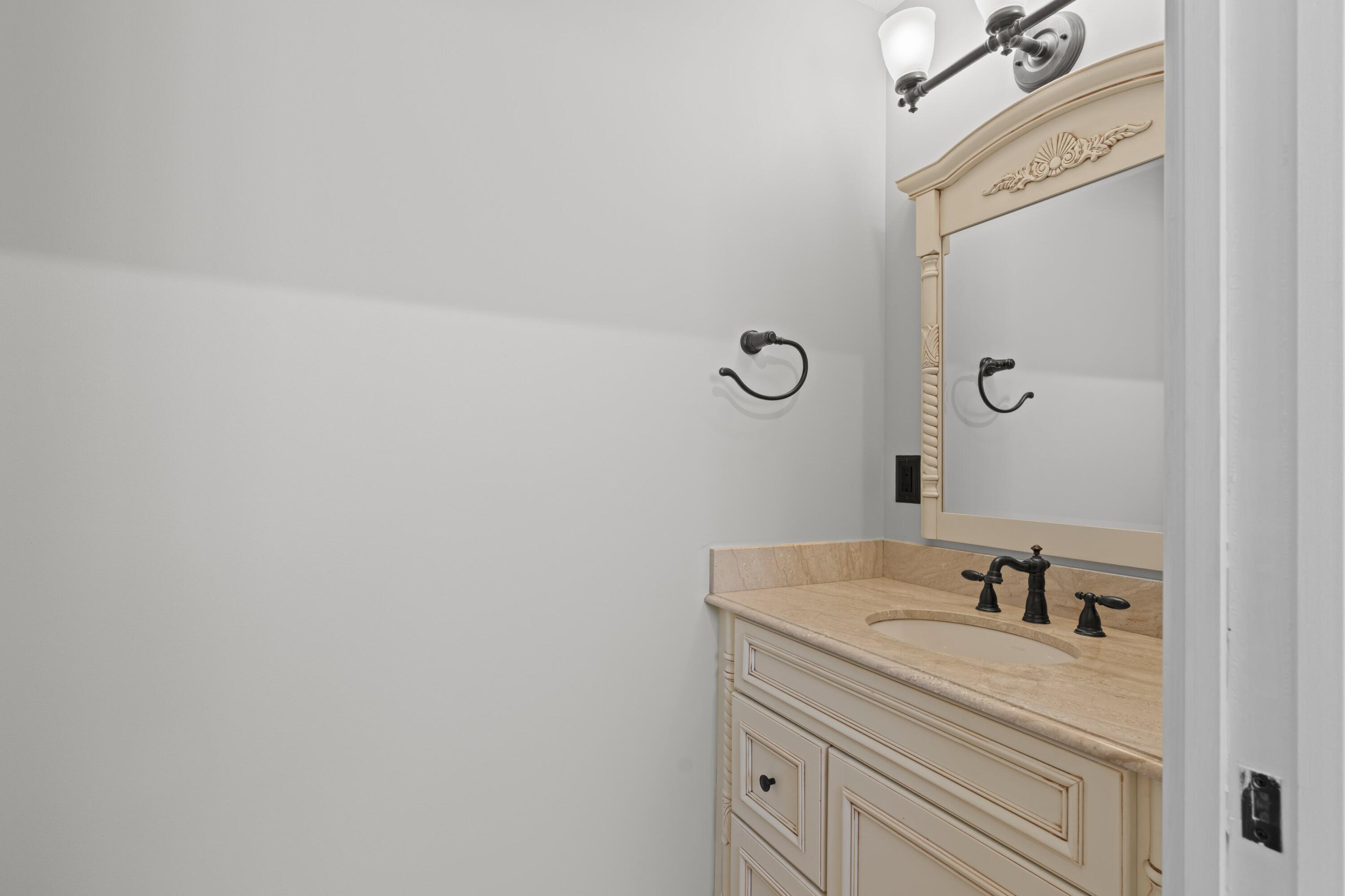 7598 Fairway Trail Boca Raton, FL 33487 - Photo 16 of 50 a bathroom with a sink and a mirror