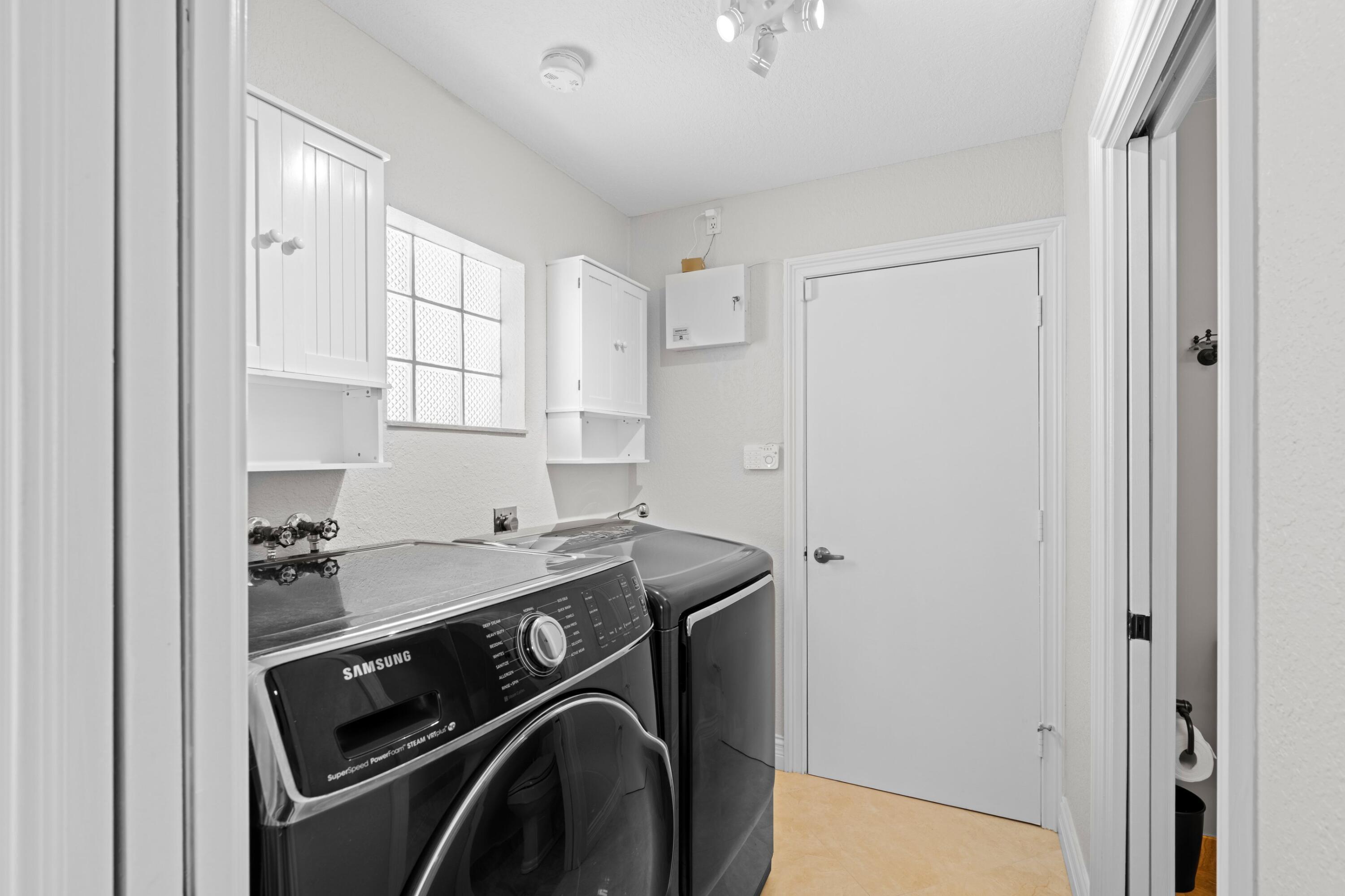 7598 Fairway Trail Boca Raton, FL 33487 - Photo 17 of 50 a utility room with stainless steel appliances washer and dryer