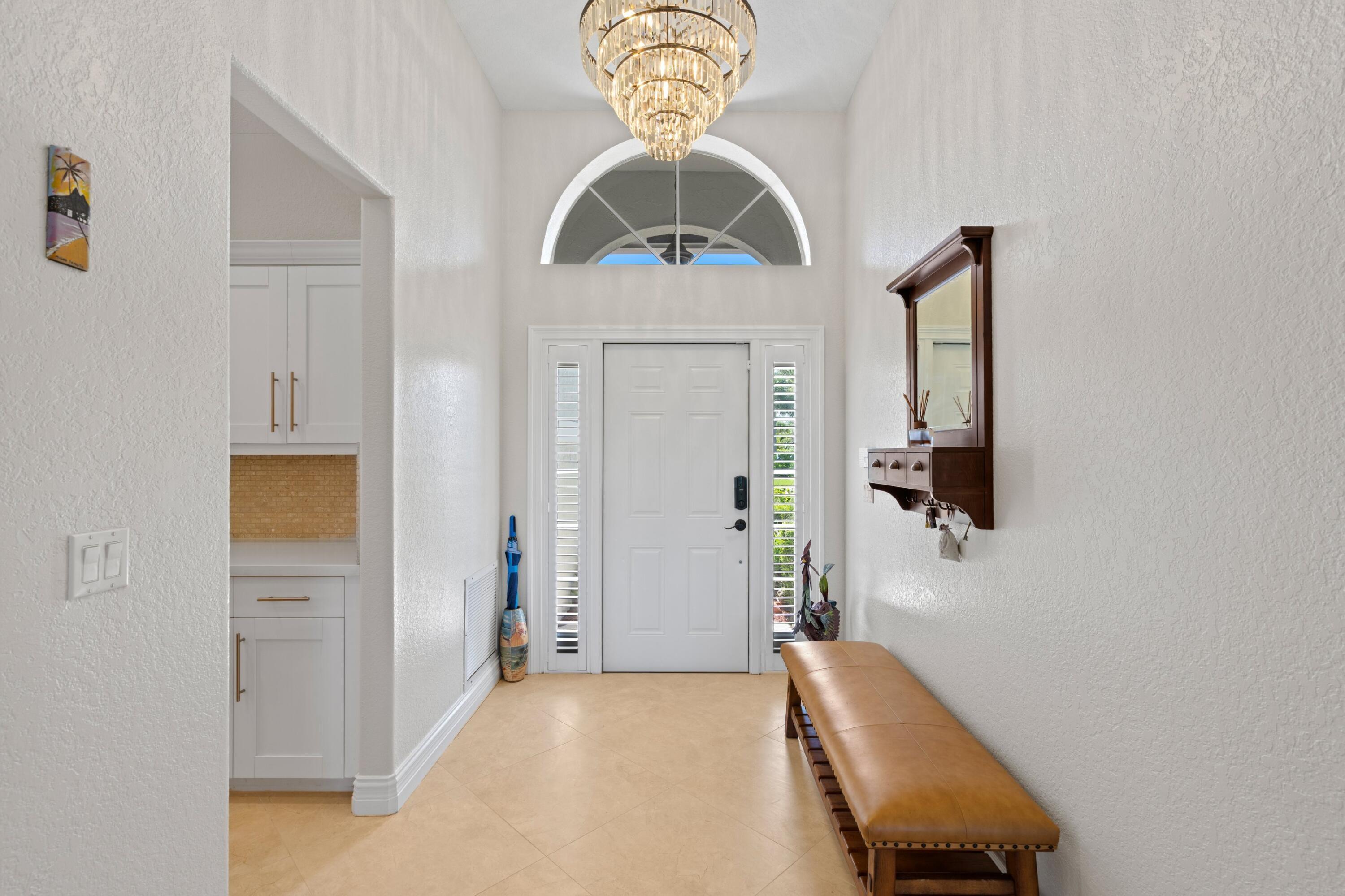 7598 Fairway Trail Boca Raton, FL 33487 - Photo 18 of 50 a bedroom with a bed and a chandelier