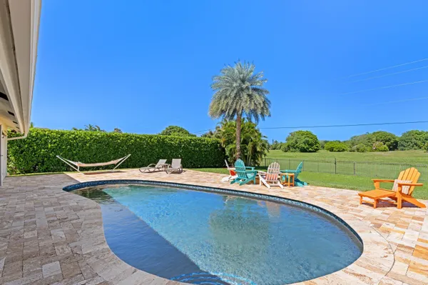 a view of a swimming pool with a lounge chairs