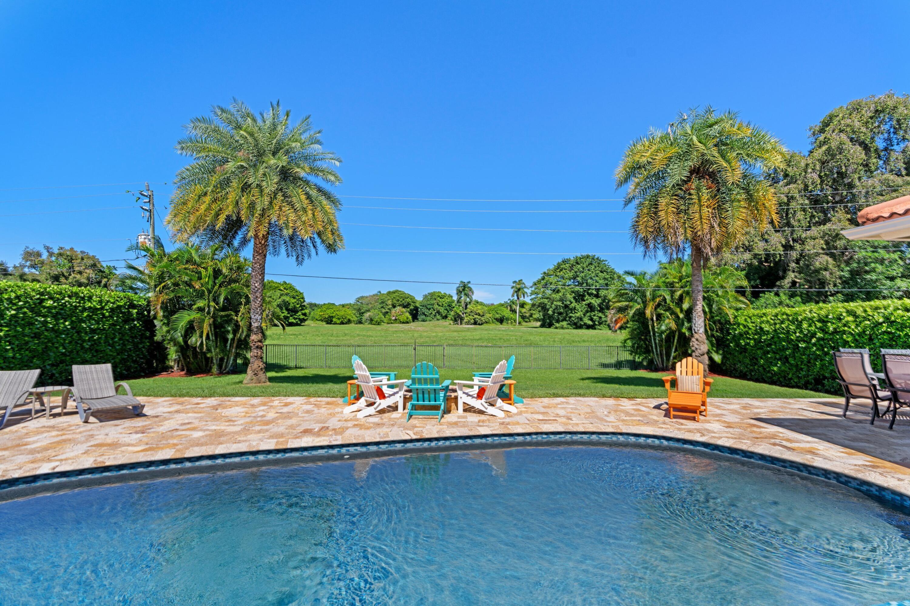 7598 Fairway Trail Boca Raton, FL 33487 - Photo 21 of 50 a view of a swimming pool with a patio