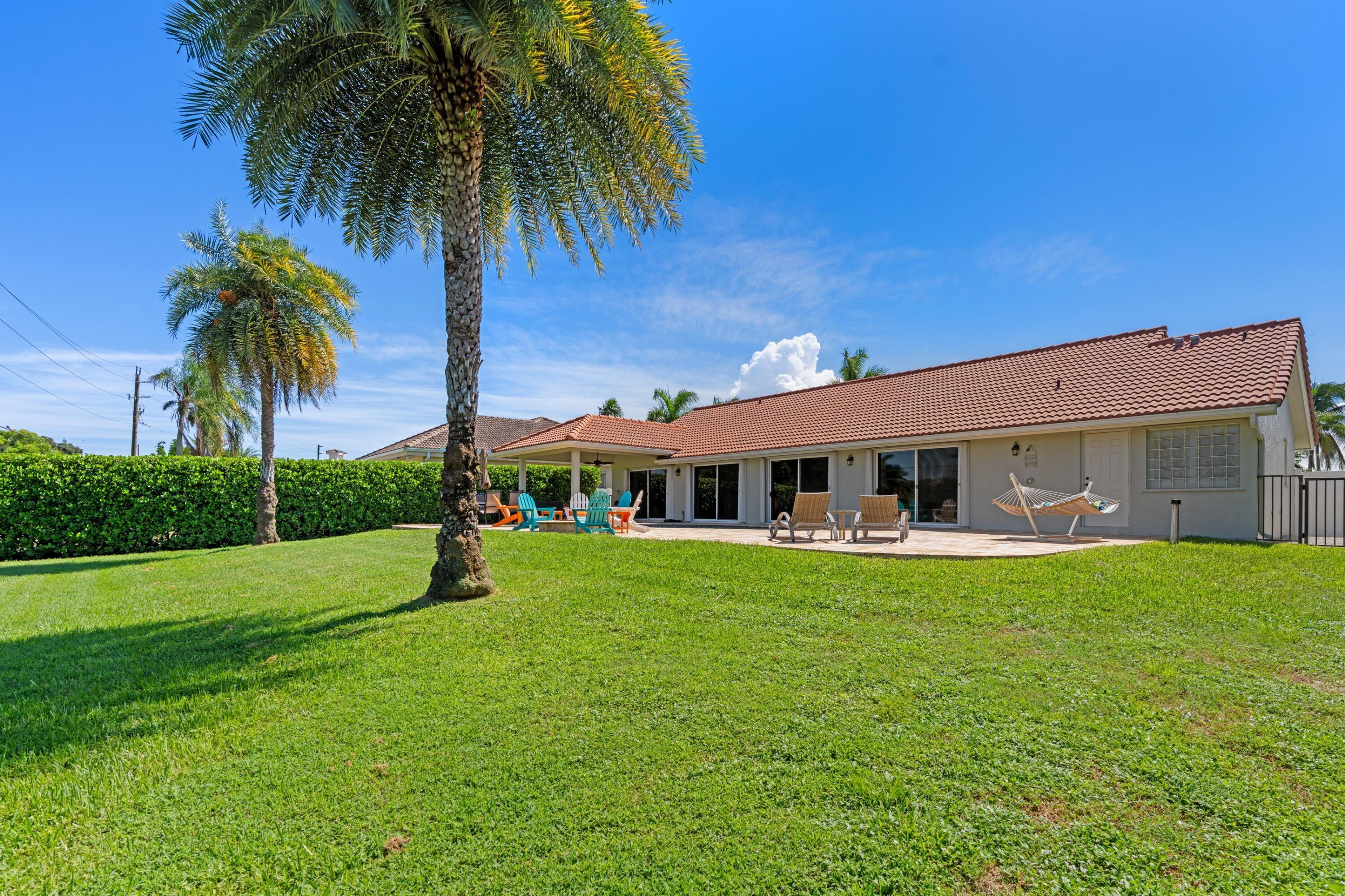 7598 Fairway Trail Boca Raton, FL 33487 - Photo 25 of 50 a view of a house with a big yard