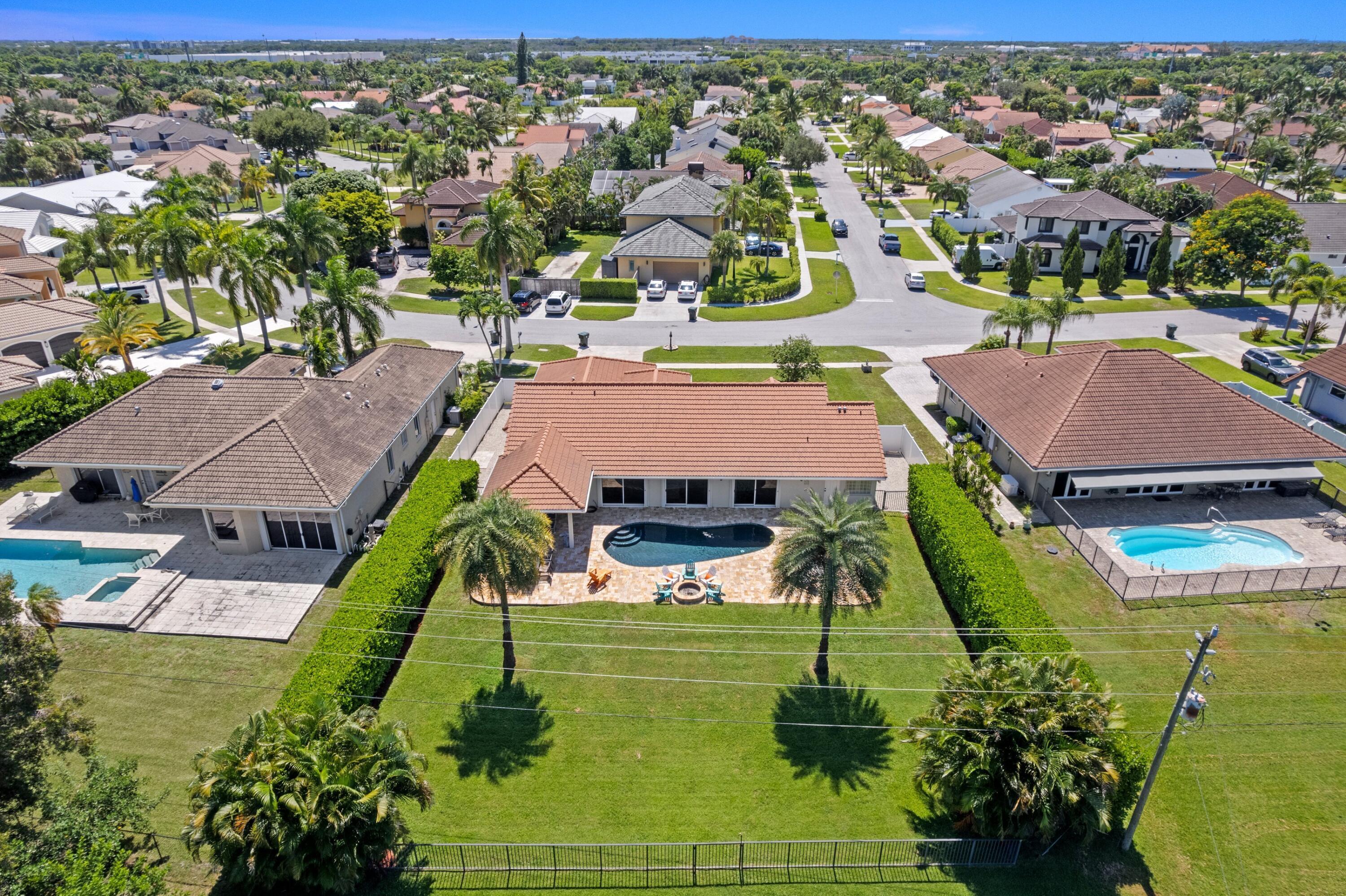 7598 Fairway Trail Boca Raton, FL 33487 - Photo 26 of 50 an aerial view of residential houses with outdoor space and swimming pool