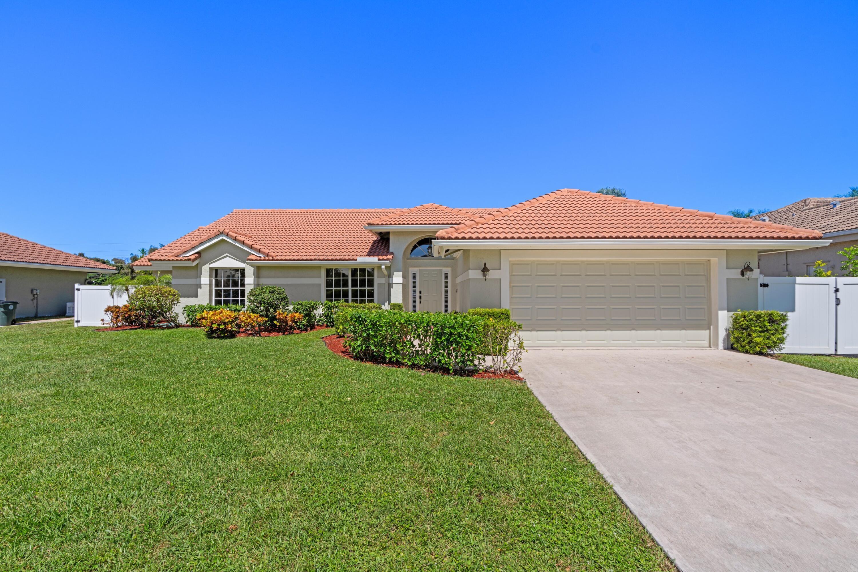 7598 Fairway Trail Boca Raton, FL 33487 - Photo 28 of 50 a front view of house with yard and green space