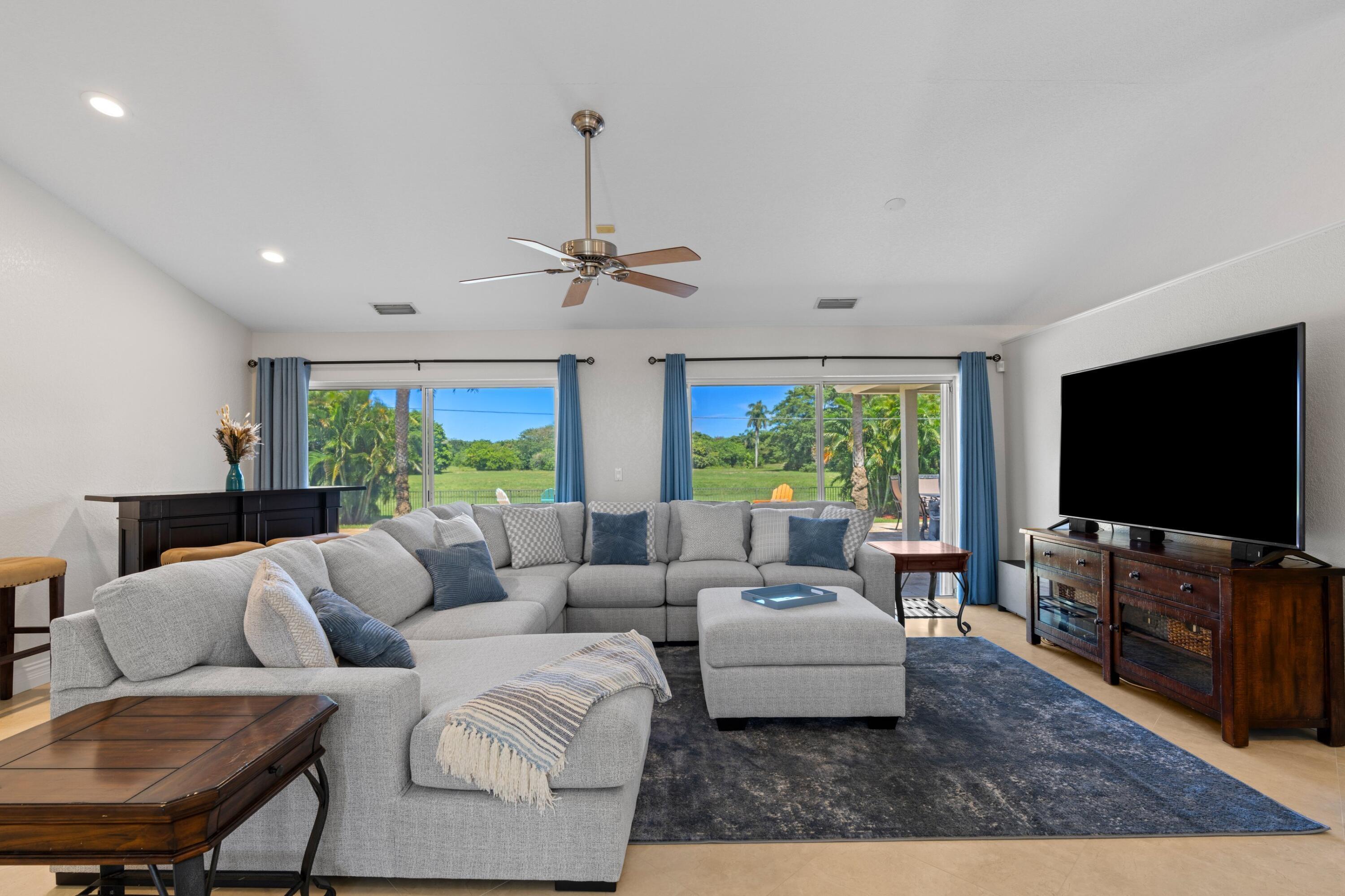 7598 Fairway Trail Boca Raton, FL 33487 - Photo 5 of 50 a living room with furniture and a flat screen tv