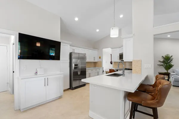 a kitchen with stainless steel appliances a refrigerator a sink a stove and cabinets