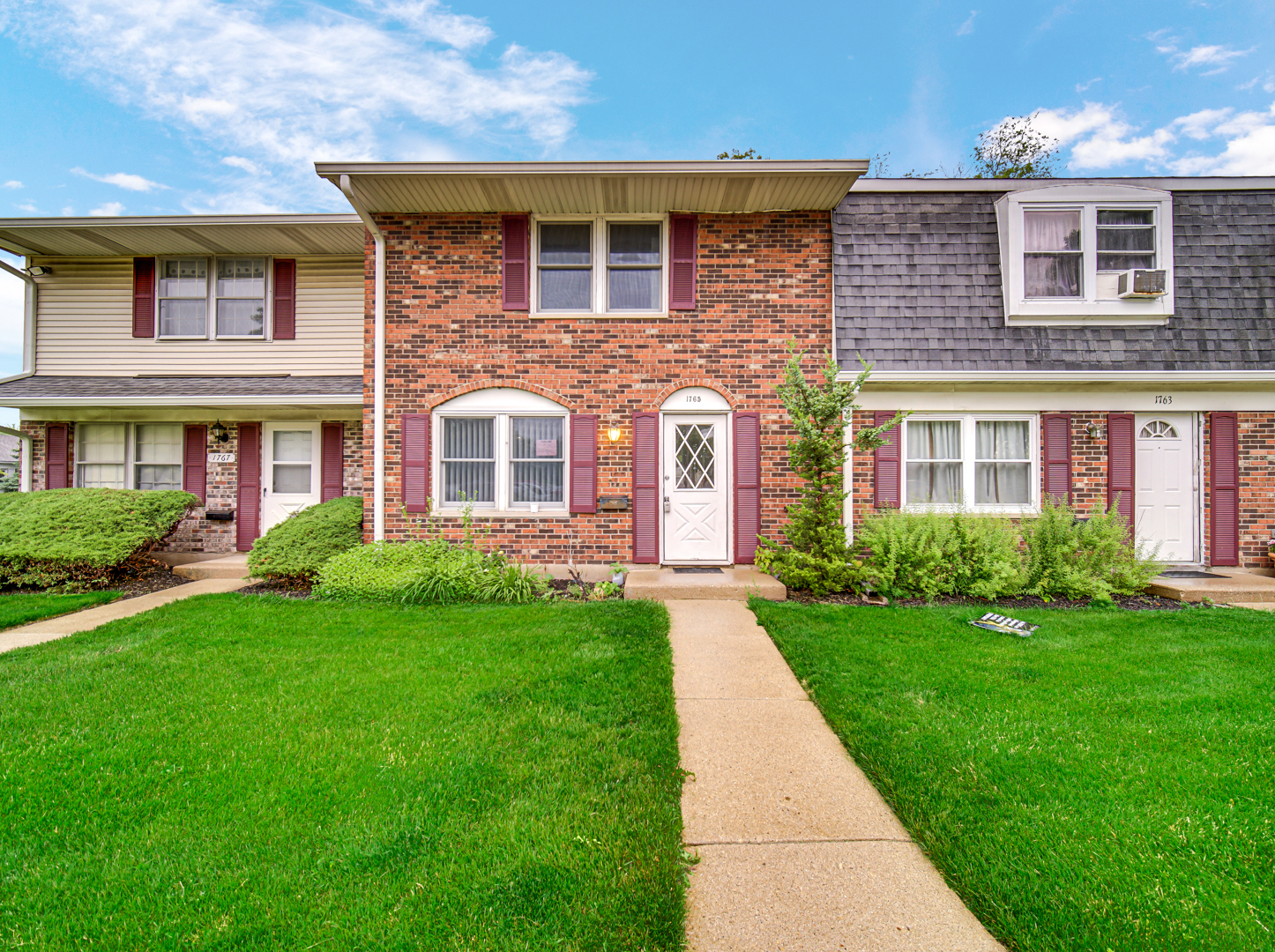 1765 Short Avenue Streamwood, IL 60107 - Photo 1 of 18 a front view of a house with garden