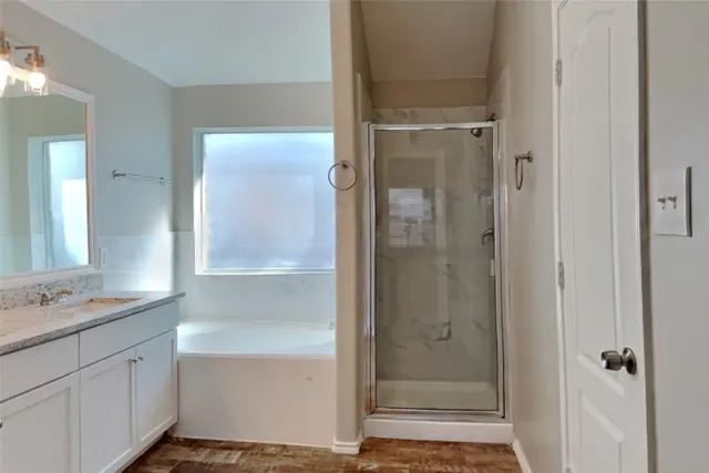 a bathroom with a shower sink and mirror