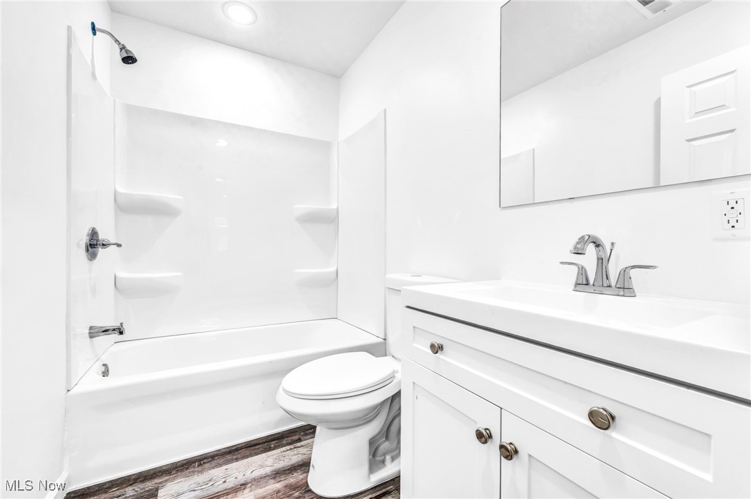 3709 Sudbury Road Cleveland, OH 44120 - Photo 24 of 29 Full bathroom with wood-type flooring, toilet, shower / washtub combination, and vanity