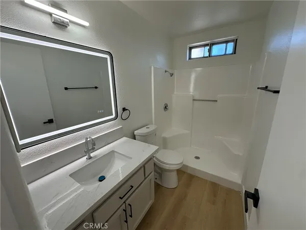 a bathroom with a sink shower and a toilet