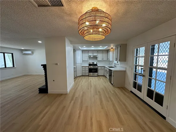 a view of kitchen with sink and wooden floor