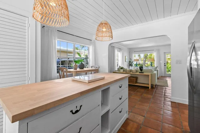 a view of living room kitchen with island and stainless steel appliances