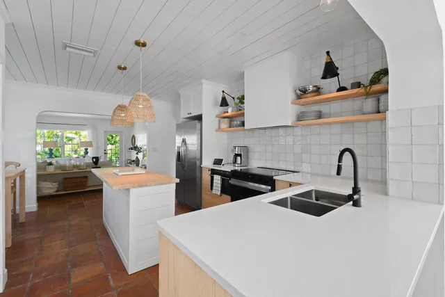 a kitchen that has a sink and a stove