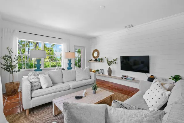 a living room with furniture and a flat screen tv