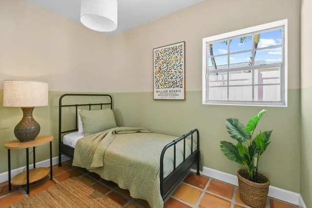 a bedroom with a bed and a lamp on table