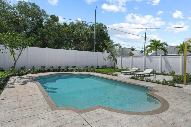 a view of a patio with couches and table and chairs and potted plants
