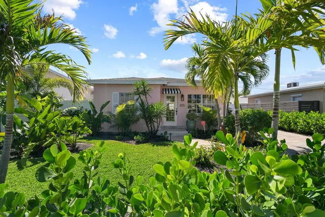 a view of a house with a flower garden