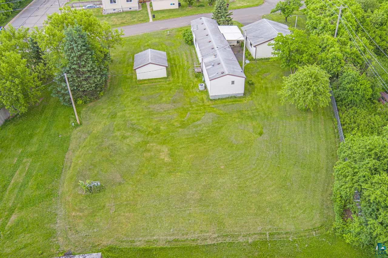 705 4th Street North Biwabik, MN 55708 - Photo 27 of 29 Expansive green lot featuring a long residential structure and two outbuildings