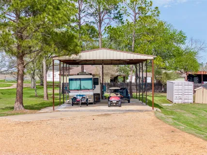 a view of a park with furniture and a small yard