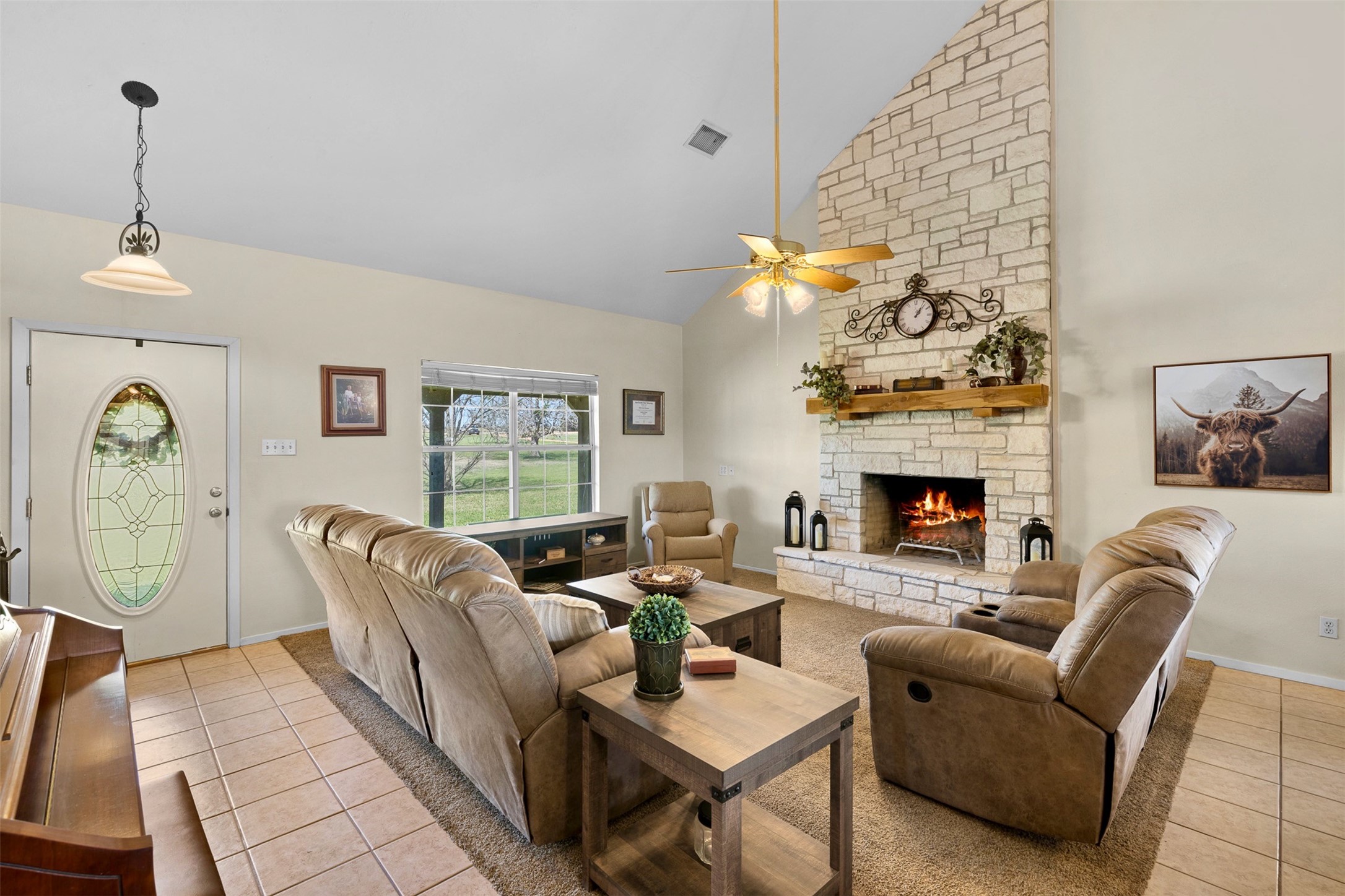 999 Salem Road Brenham, TX 77833 - Photo 20 of 41 a living room with furniture a fireplace and a table