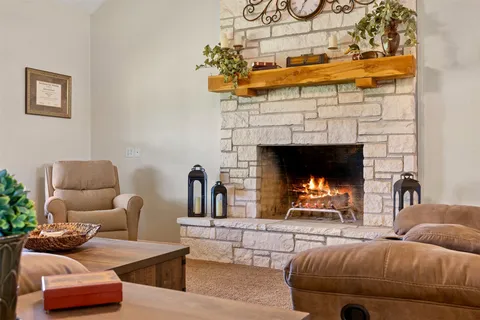 a living room with furniture and a fireplace