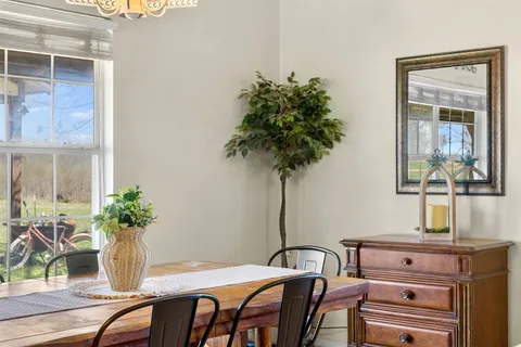 a view of a dining room with furniture window and outside view