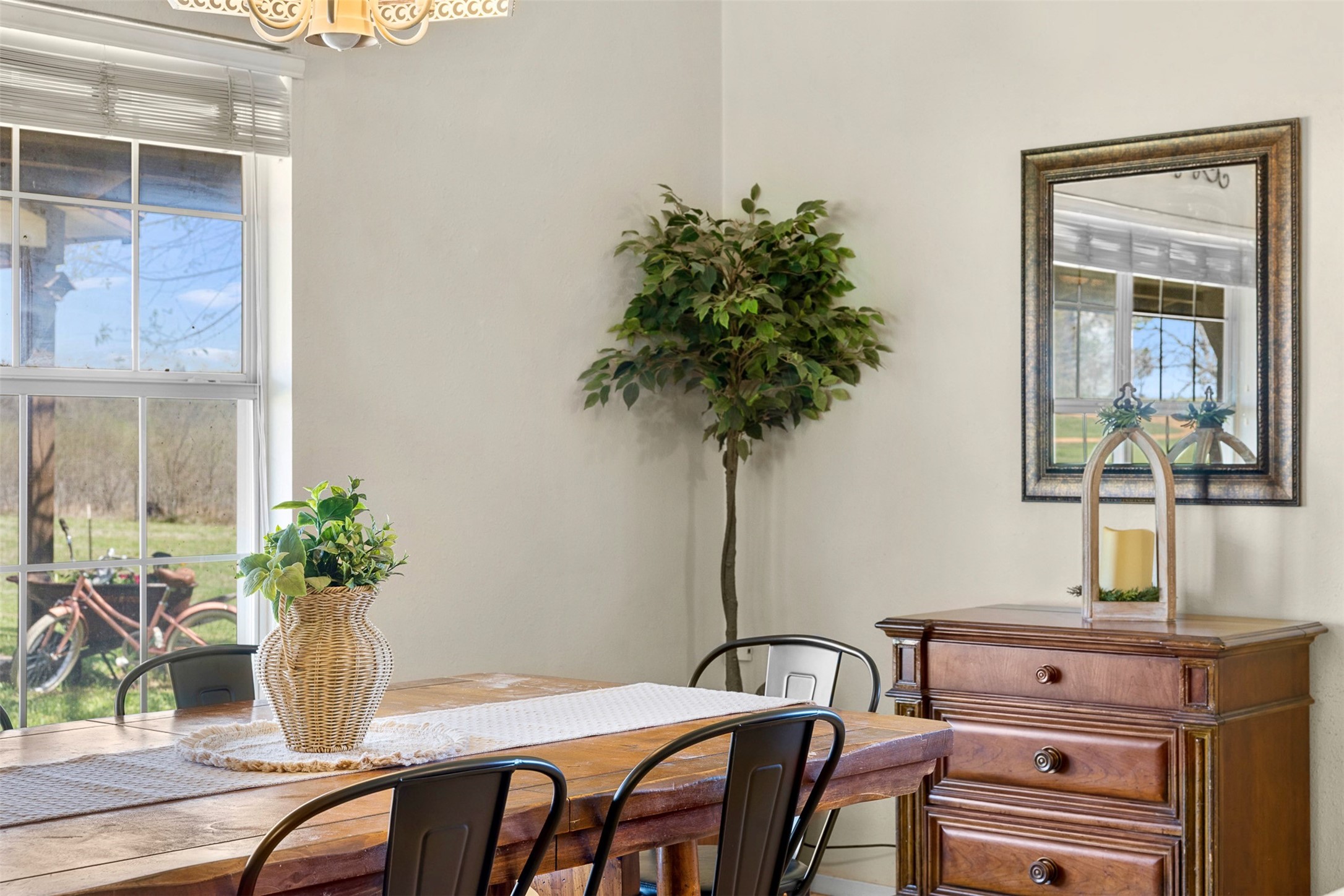 999 Salem Road Brenham, TX 77833 - Photo 26 of 41 a table with chairs and a potted plant
