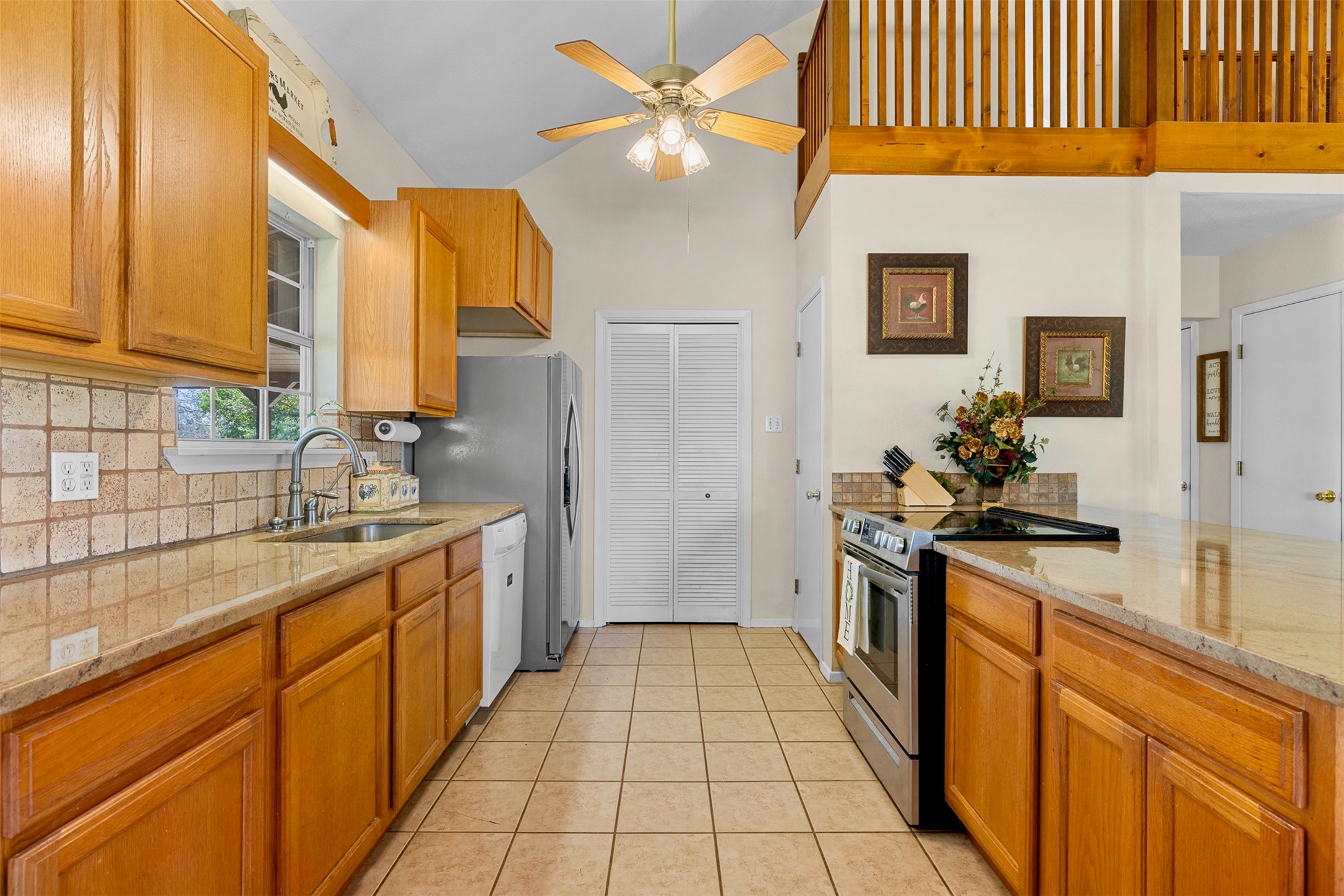 999 Salem Road Brenham, TX 77833 - Photo 29 of 41 a kitchen with stainless steel appliances granite countertop a sink and a refrigerator