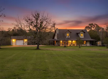 a front view of a house with a big yard