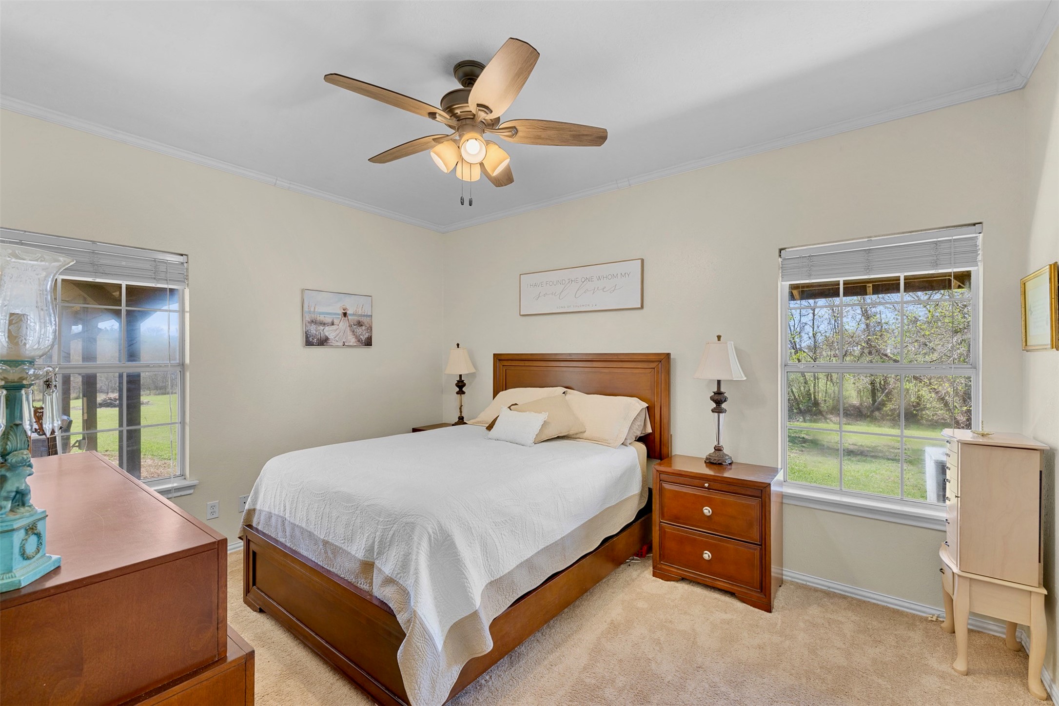 999 Salem Road Brenham, TX 77833 - Photo 31 of 41 a bedroom with a bed and a chandelier